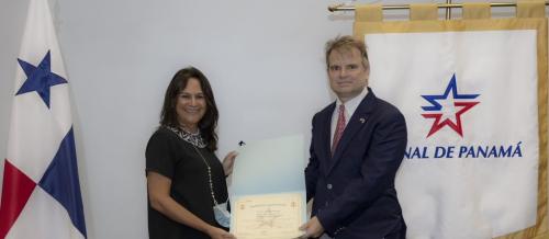 Commissioner Louis Sola (right) is awarded the Master Key and Honorary Lead Pilot distinction by Ilya Espino de Marotta (left), Deputy Administrator and Vice President for Operations, Panama Canal Authority, Panama City, Panama, January 25, 2022.