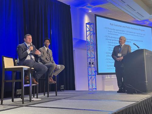 Chairman Daniel Maffei (left) speaking at the 2022 “TransportationGo” event. He is joined by co-panelistSurface Transportation Board Member Robert Primus (center) and moderator Mike Steenhoek (right)